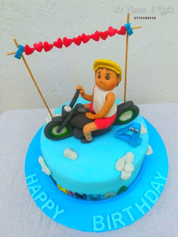Fondant boy on the bike cake