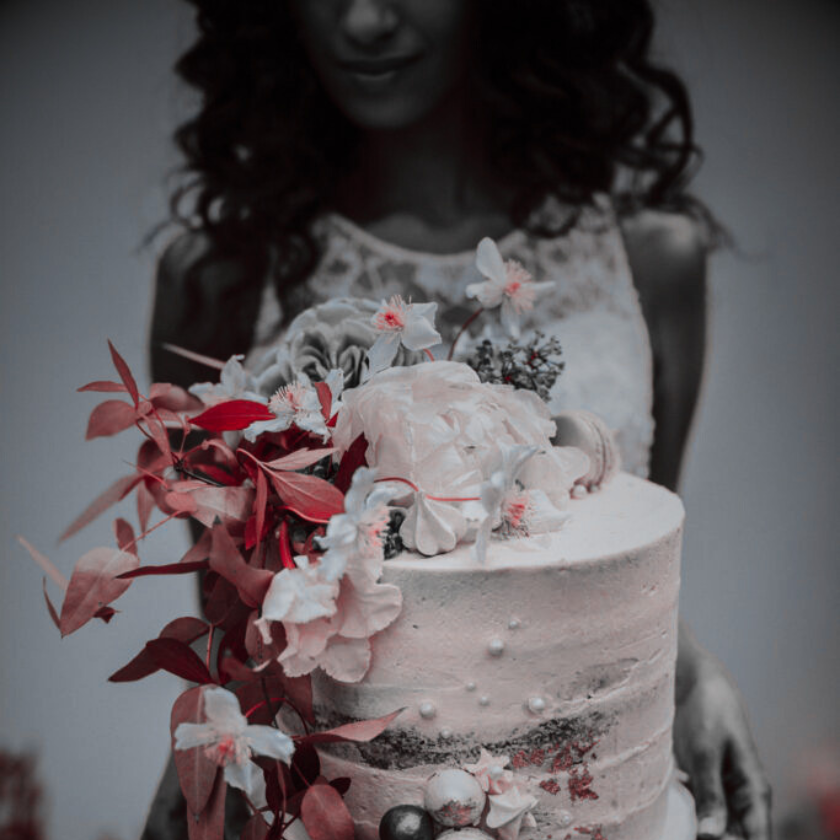 Cake designer decorating with sugar flowers wedding cake structure