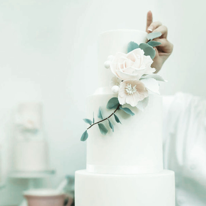 Cake designer decorating with sugar flowers